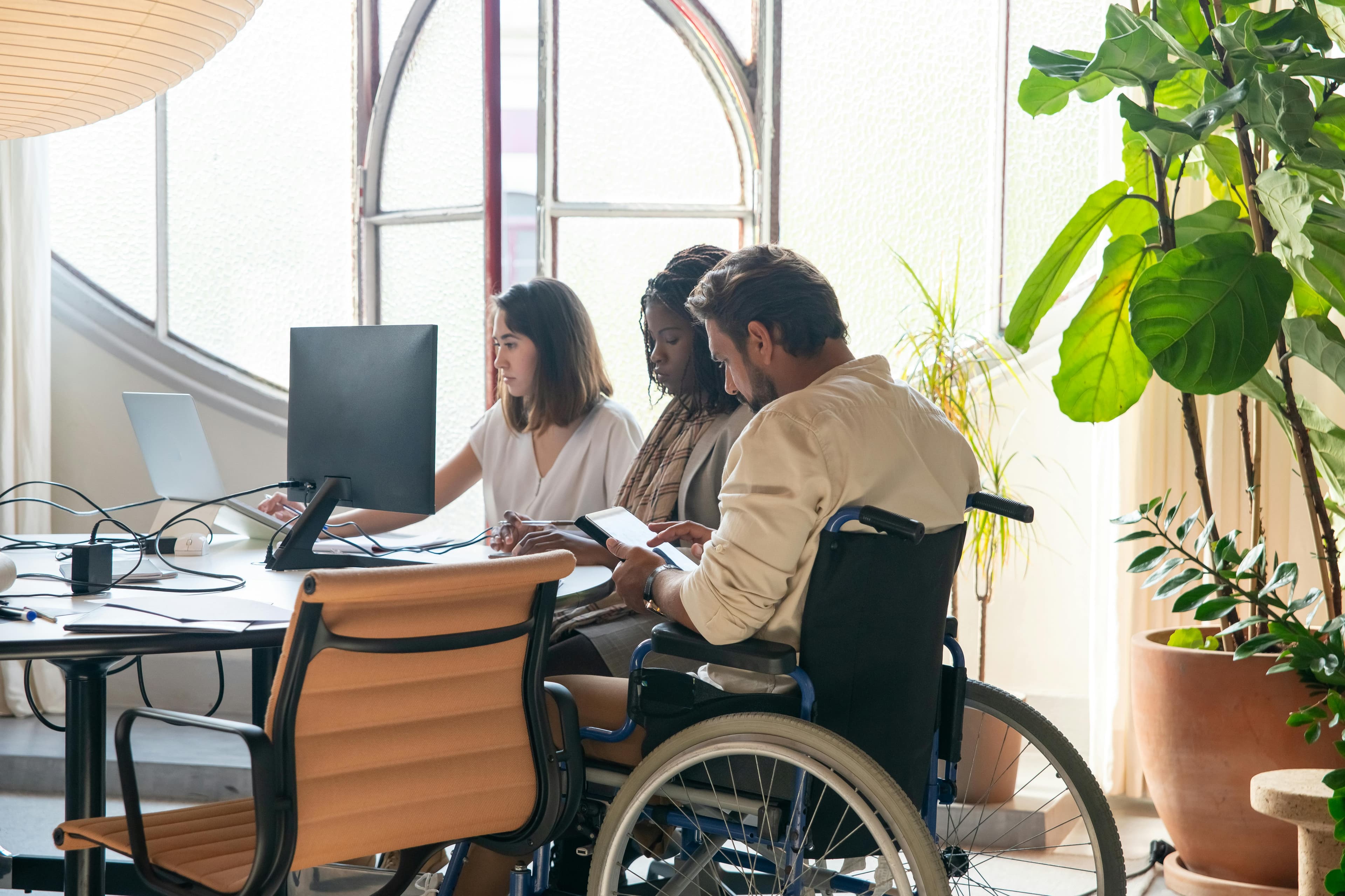 Inclusive workplace team handling everyday operations in a shared office